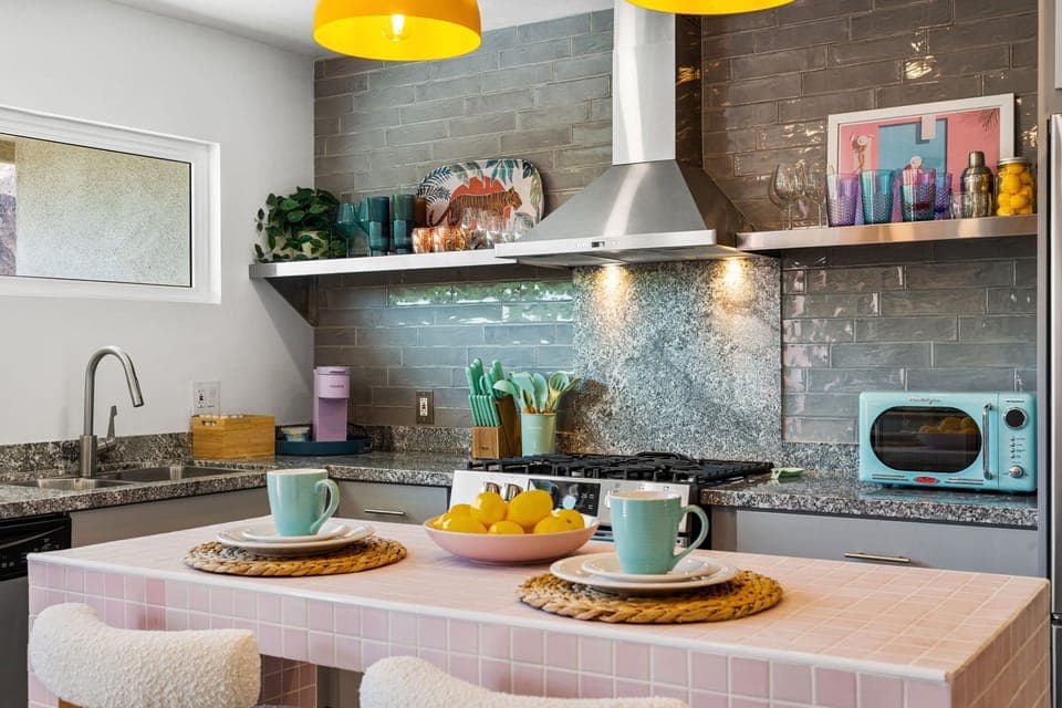 Bright kitchen with retro accents, island seating & gas range