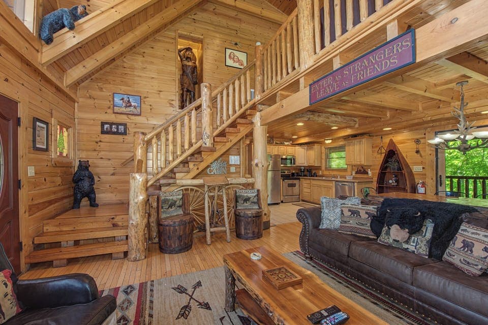 Step into your rustic retreat where warm wood surrounds you, cozy leather seating awaits, and whimsical bear decor creates mountain charm.