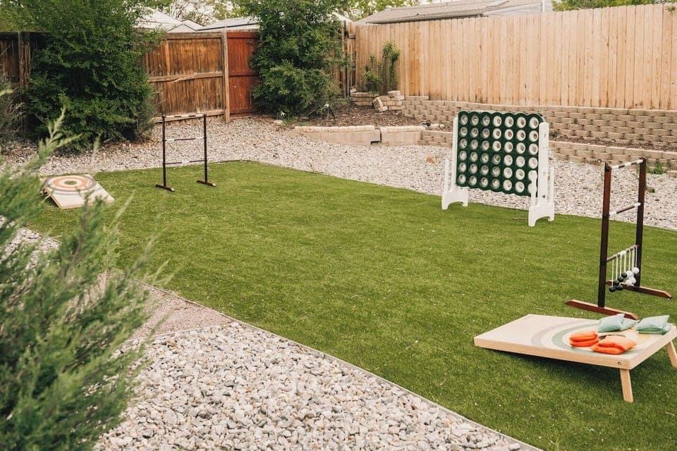 Backyard turf area with lawn games.