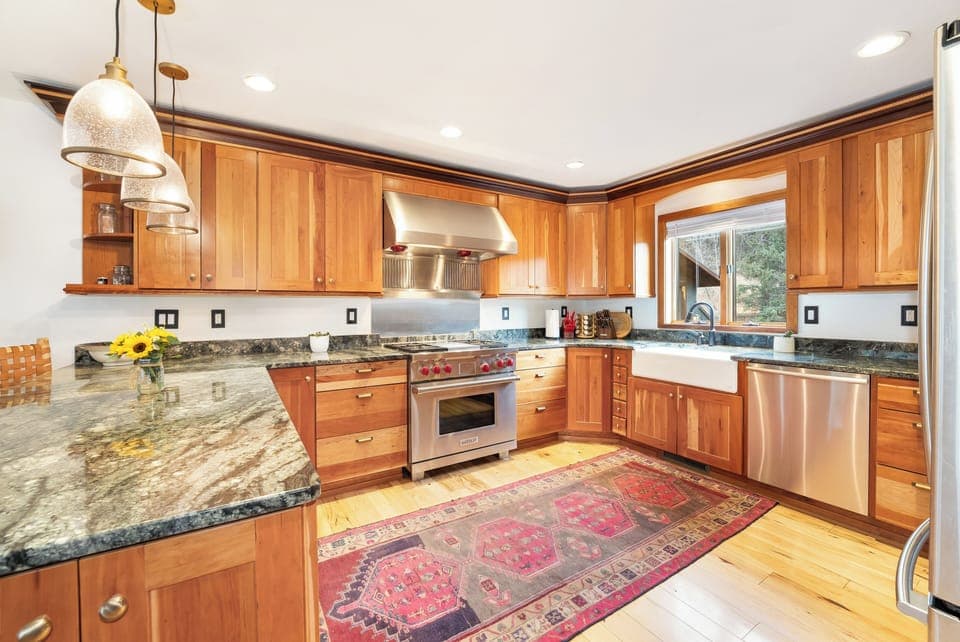 Step into your gourmet kitchen with warm wood cabinets, granite counters, and stainless appliances—perfect for creating memorable meals together.