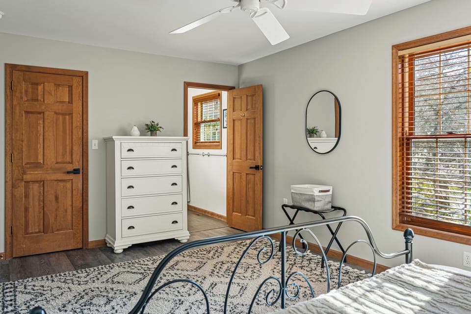 Primary bedroom features a king bed with an ensuite bathroom and a walk-in closet. (Laker's Pointe)
