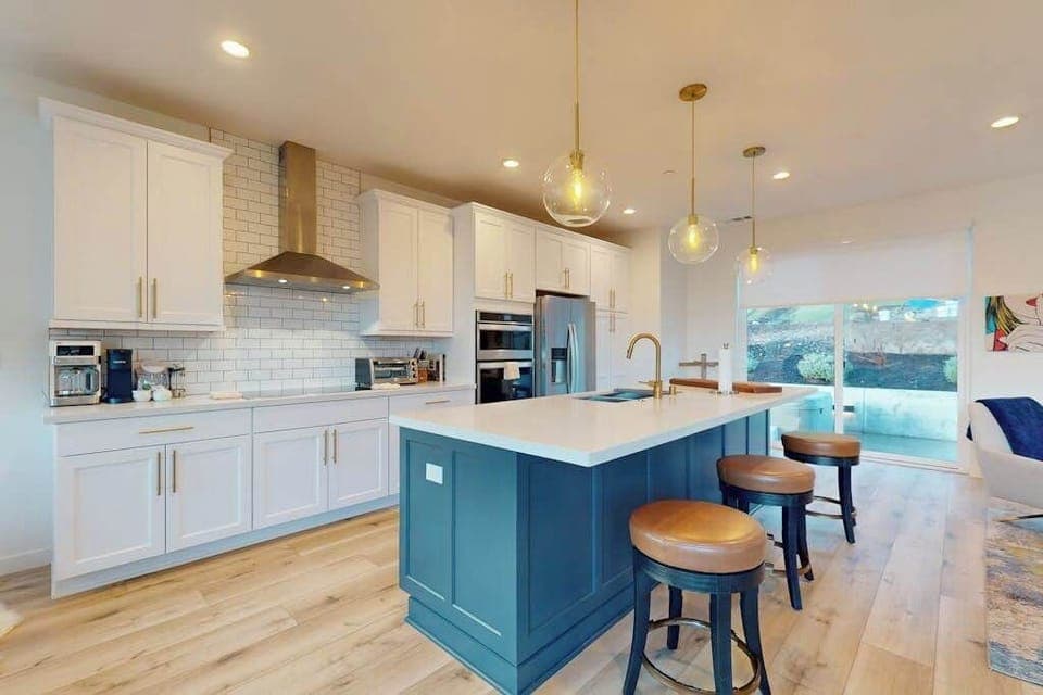 Pull up a stool and pour a tasting flight at your chef's island — white shaker cabinets, subway tile, and a pro-grade range hood complete your wine country kitchen.