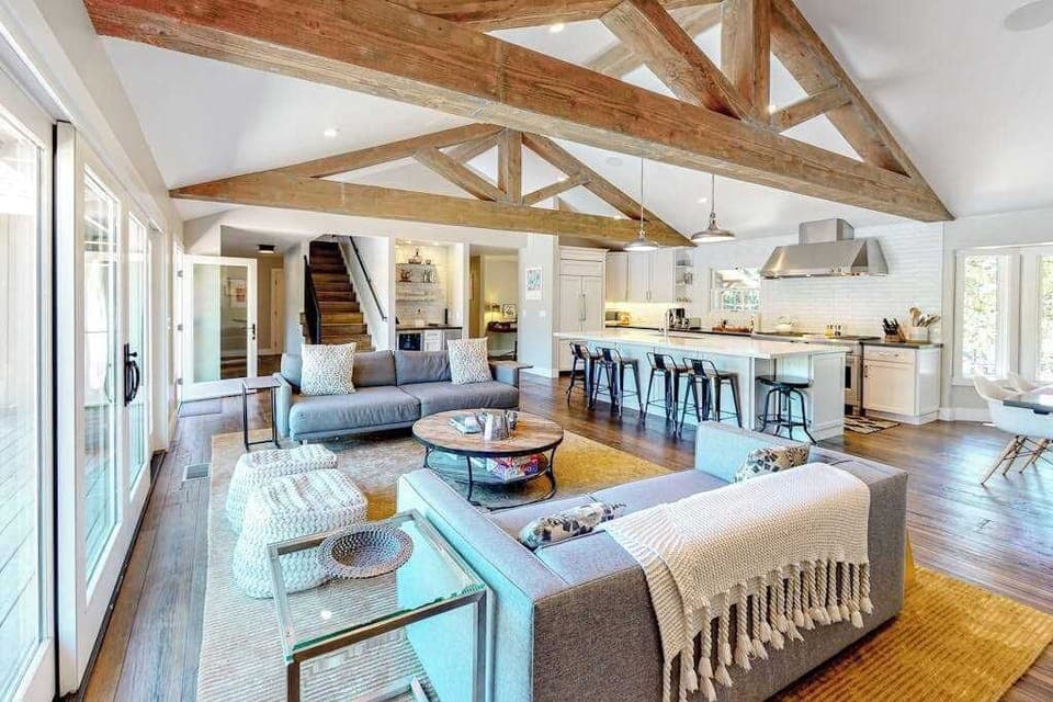 Soaring exposed timber beams crown your open-concept great room, where plush sofas and a chef's kitchen invite long Sonoma Valley evenings with your favorite bottle.
