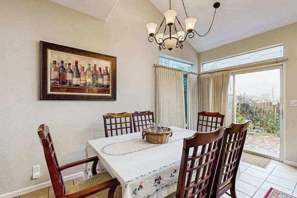 Enjoy morning coffee or a tasting-room charcuterie spread at the dining table with direct access to your private patio through the sliding glass door.