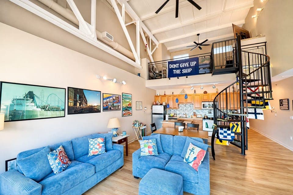 Open the doors to fresh lake air in this airy living space with nautical touches, cozy seating, and natural light pouring in.
