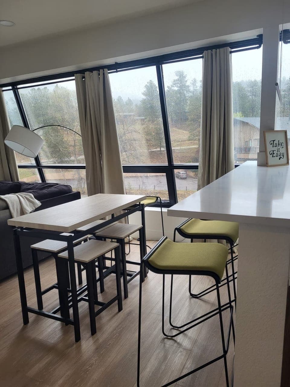 Dining room has plenty of space with a dining table and breakfast bar.  
