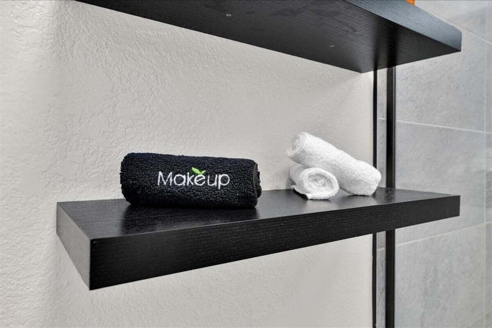 Thoughtful bathroom touches with makeup towels and open shelving