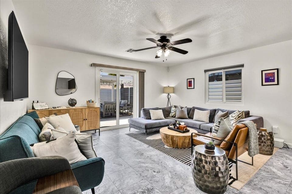 Bright modern living room with patio access and oversized sectional