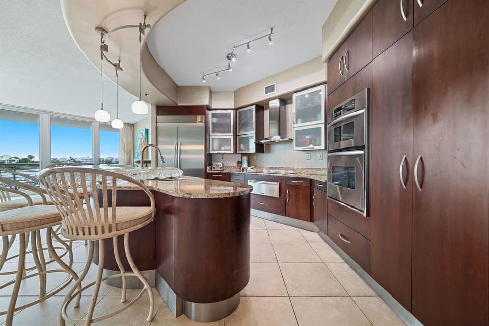 Effortless flow and abundant natural light characterize this stunning condo. The kitchen's thoughtful design and open layout create an inviting atmosphere for both cooking and gathering.