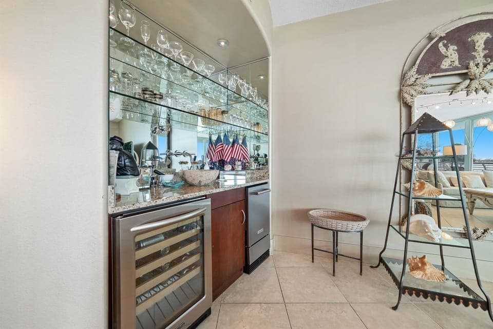 Perfect for entertaining, this dining area features a convenient wet bar with a wine cooler and blender. Create memorable gatherings in this stylish and functional space.
