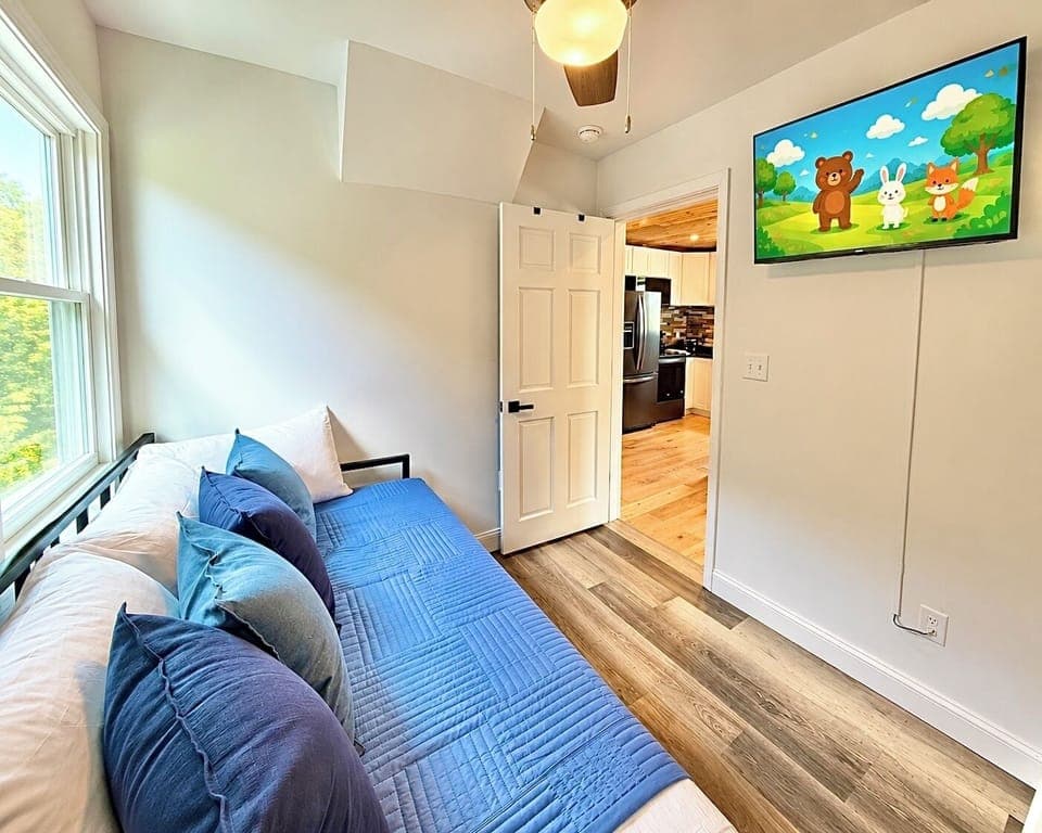 Stretch out and unwind in this spacious retreat featuring a plush bed, futon seating, and a mounted TV for laid-back evenings indoors.