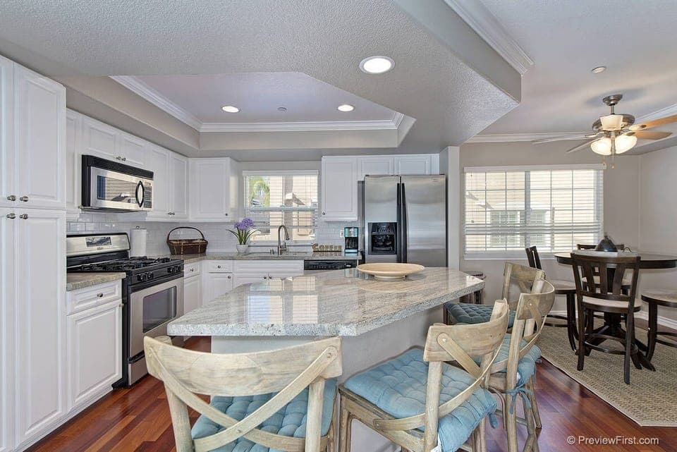 Kitchen is upgraded with island and bar stools