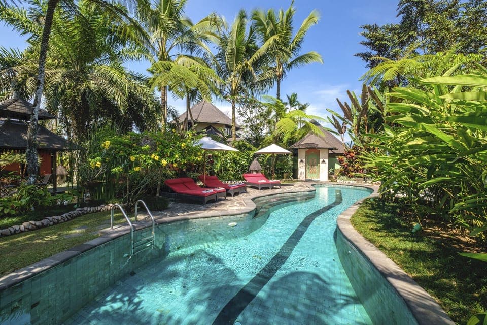 Outdoor Pool Surrounded by 6 Chairs