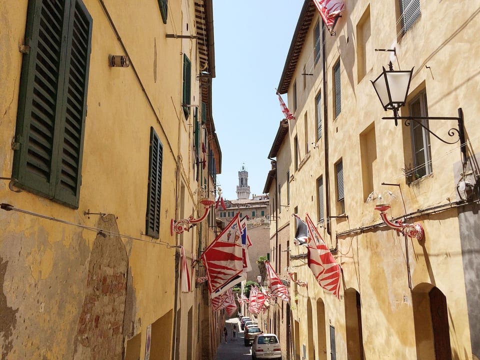 The apartment is located in this typical Senese street. View on Torre d. Mangia