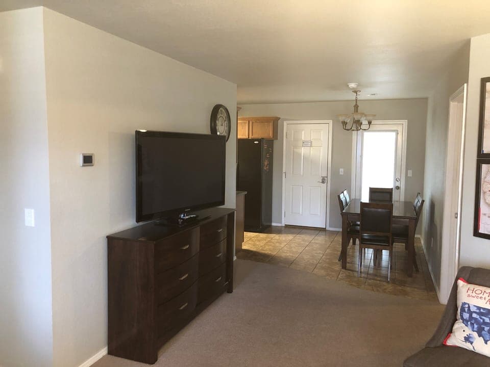 The 50 inch flatscreen TV is visible from the living and dining areas.