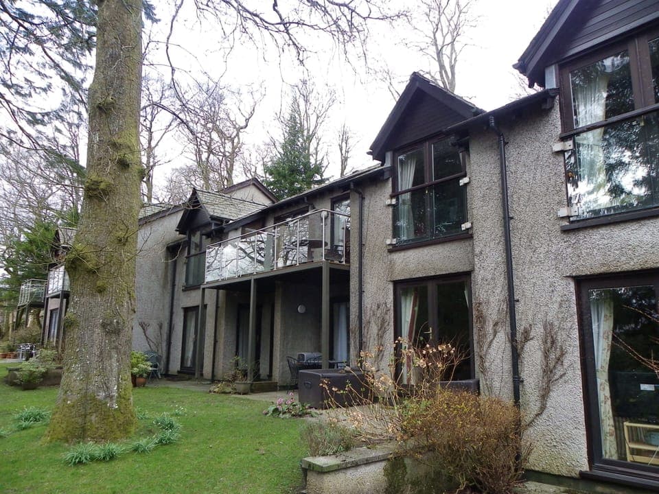 The flat is upstairs with a balcony overlooking the grounds at the rear.