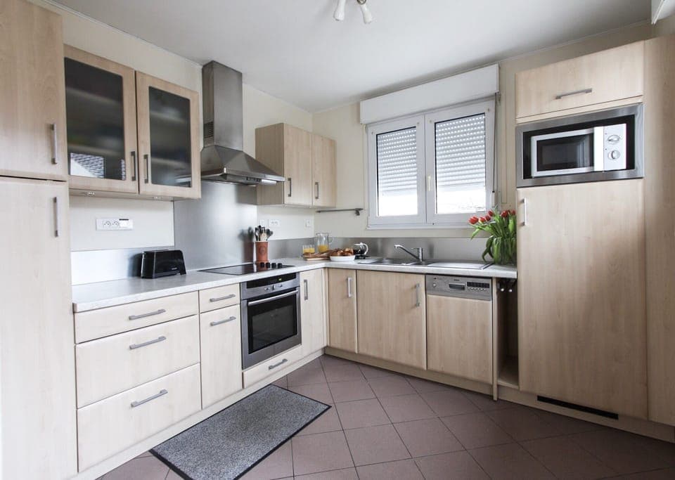Fully equipped kitchen with access to courtyard.