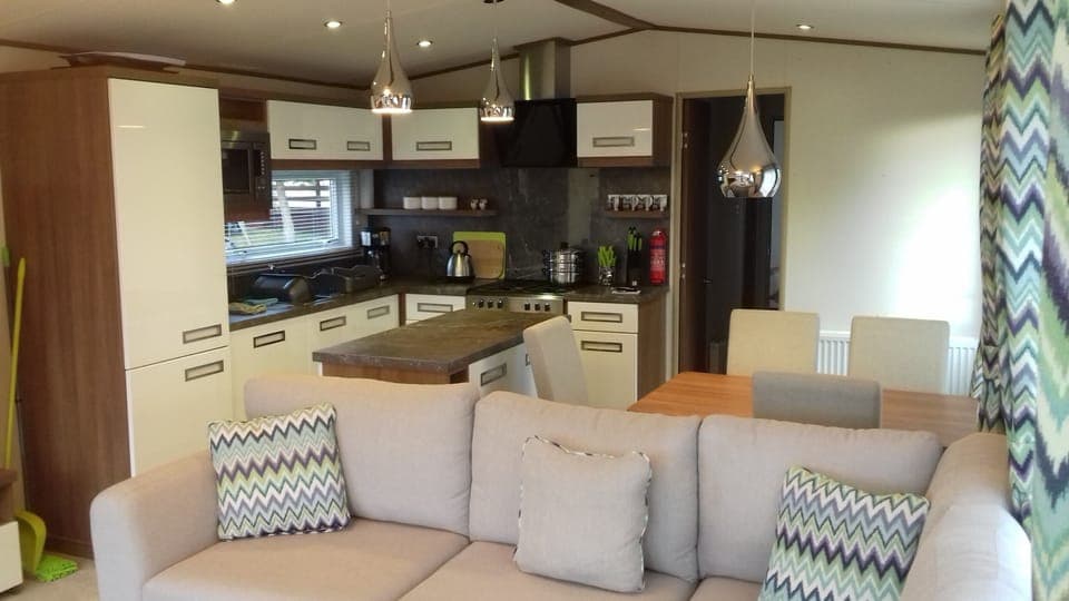 Kitchen with breakfast bar and table/chairs.