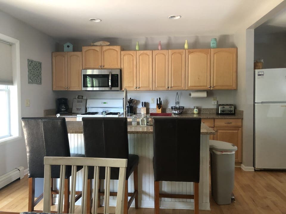 Fully equipped kitchen with additional seating at island. 