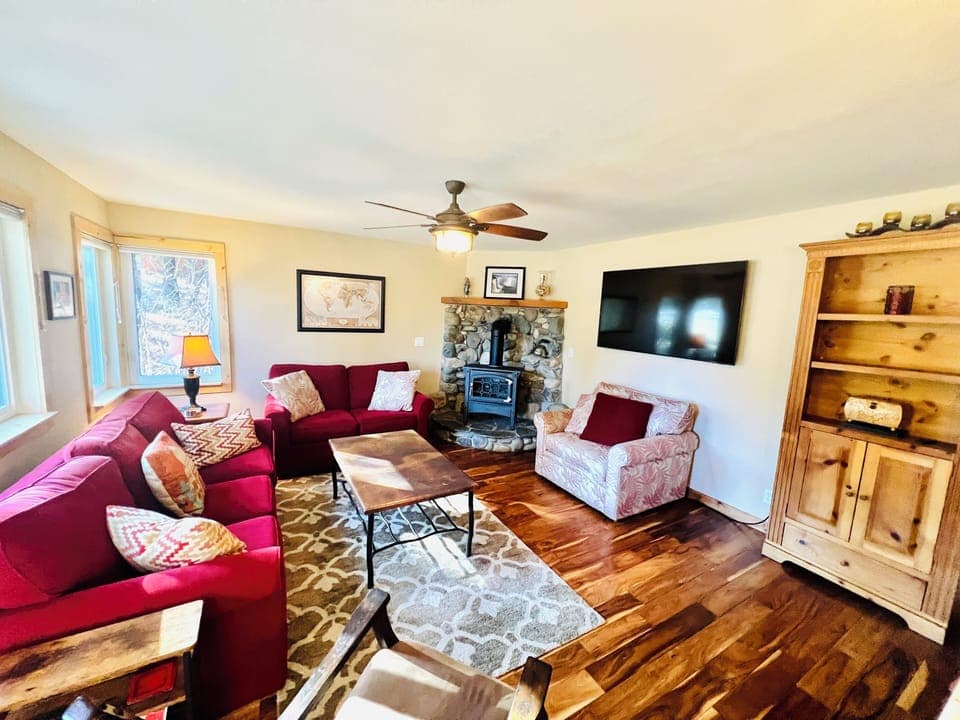 Living room with gas fireplace and upgraded TV