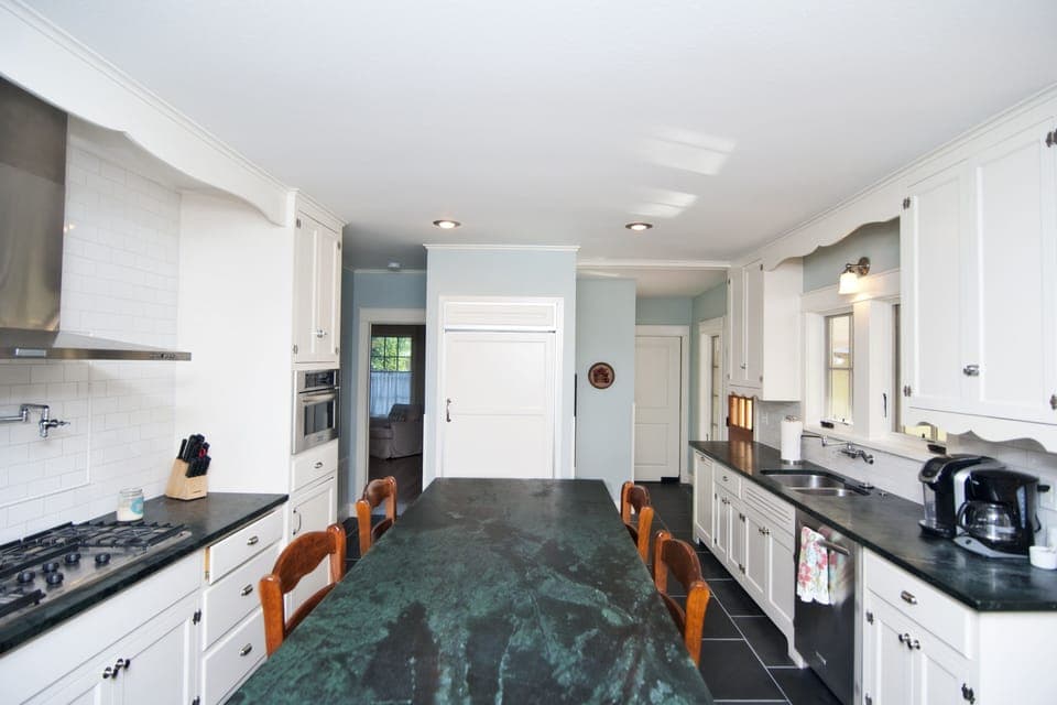 Large chef's kitchen with Kitchen Aid stove, fridge, dishwasher and microwave.