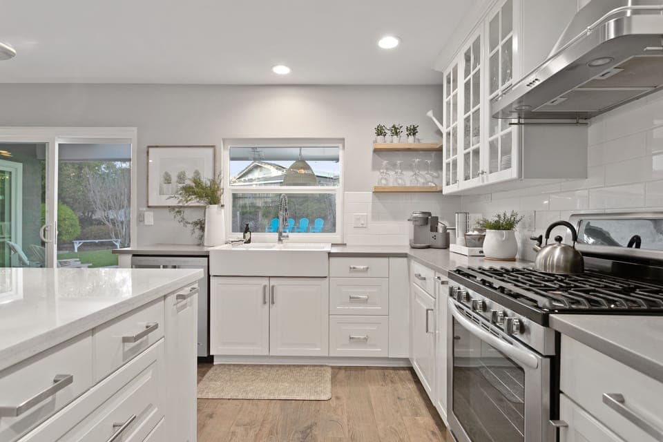Kitchen with a view of outdoor dining + backyard.
