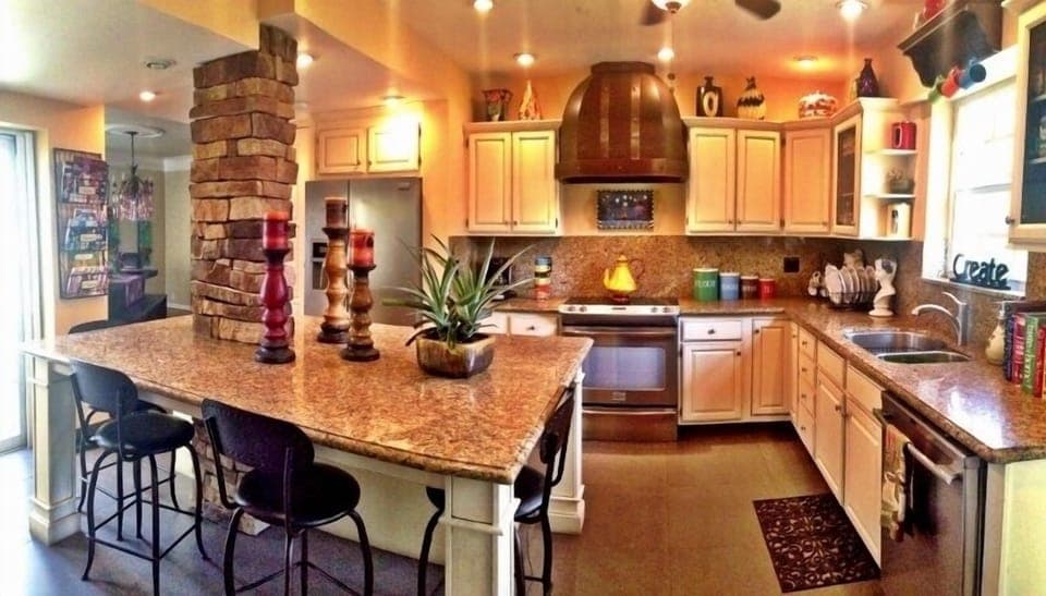 Fully stocked kitchen. Large island with bar stools.
