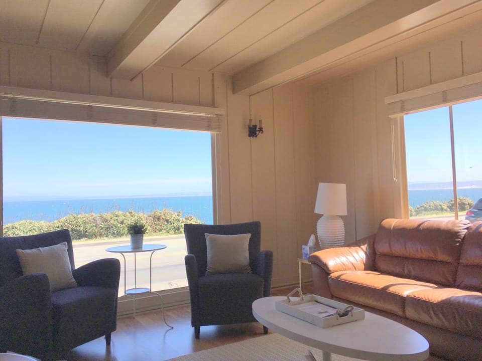 living room has fireplace, 50 inch TV and Ocean View.