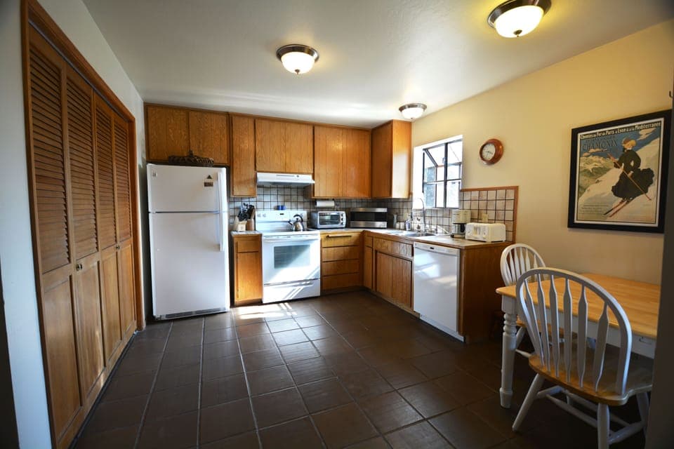 Kitchen with newer Kenmore appliances, stocked with cookware and utensils