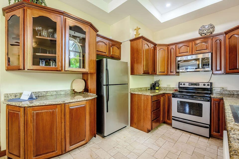 Mahogany and granite highlight the fully-equipped kitchen!