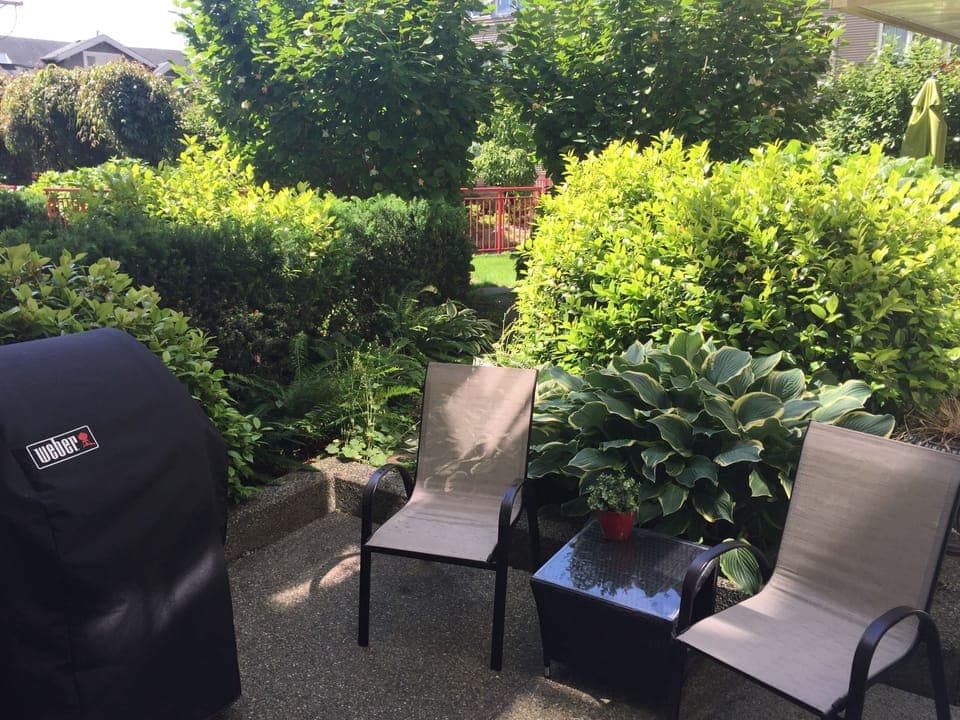 BBQ and chairs  in a very private corner of the courtyard 