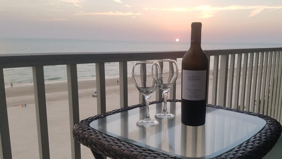 Enjoy a glass of wine on the balcony at Sunset.