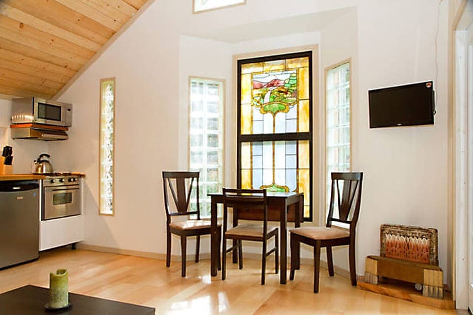 The living room features an antique stained glass feature window.