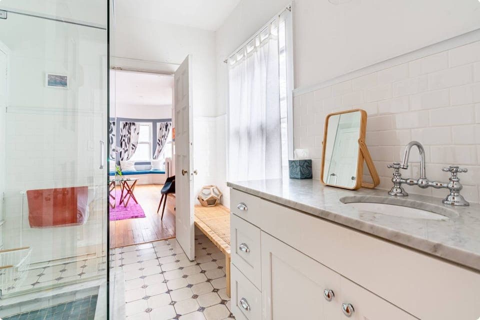 Second floor Jack and Jill bathroom with walk-in glass shower.