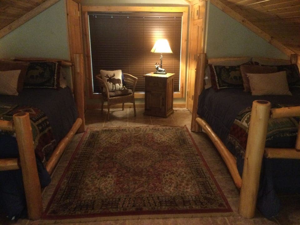Rustic loft bedroom with two full size beds.