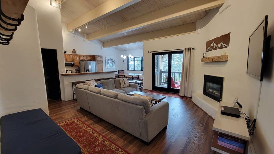 Open Main floor Great Room with vaulted ceiling, gas fireplace, and balcony.