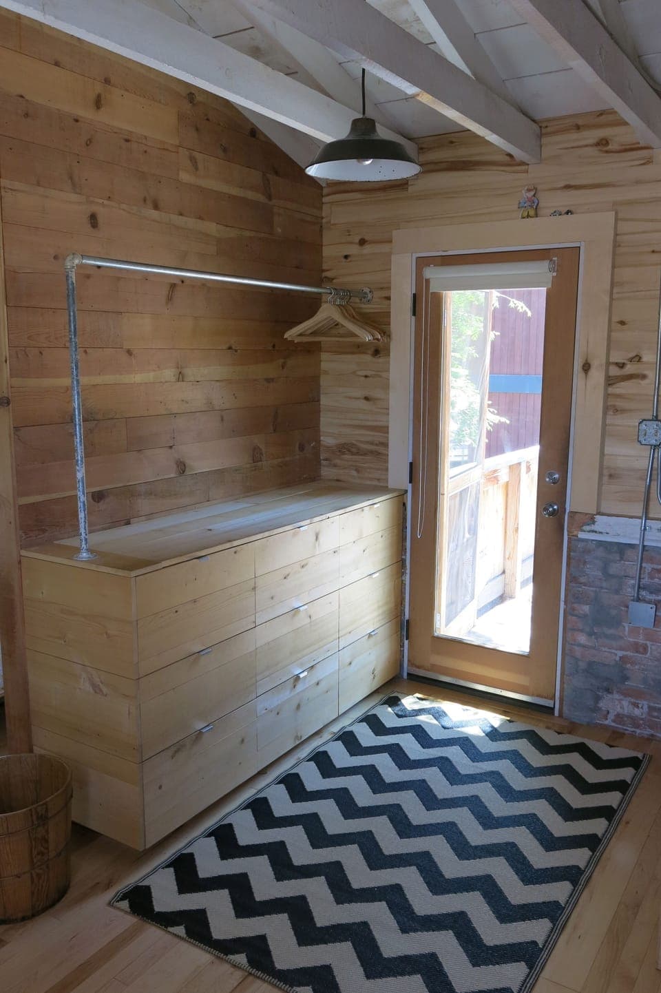 Just at the entry, a custom built cabinet provides storage for all essentials.