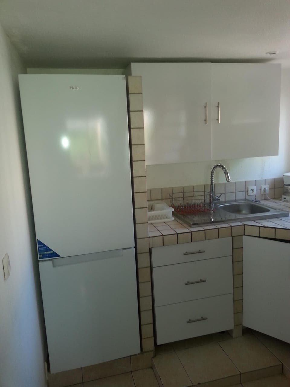 The kitchen with its fridge and its two superimposed door