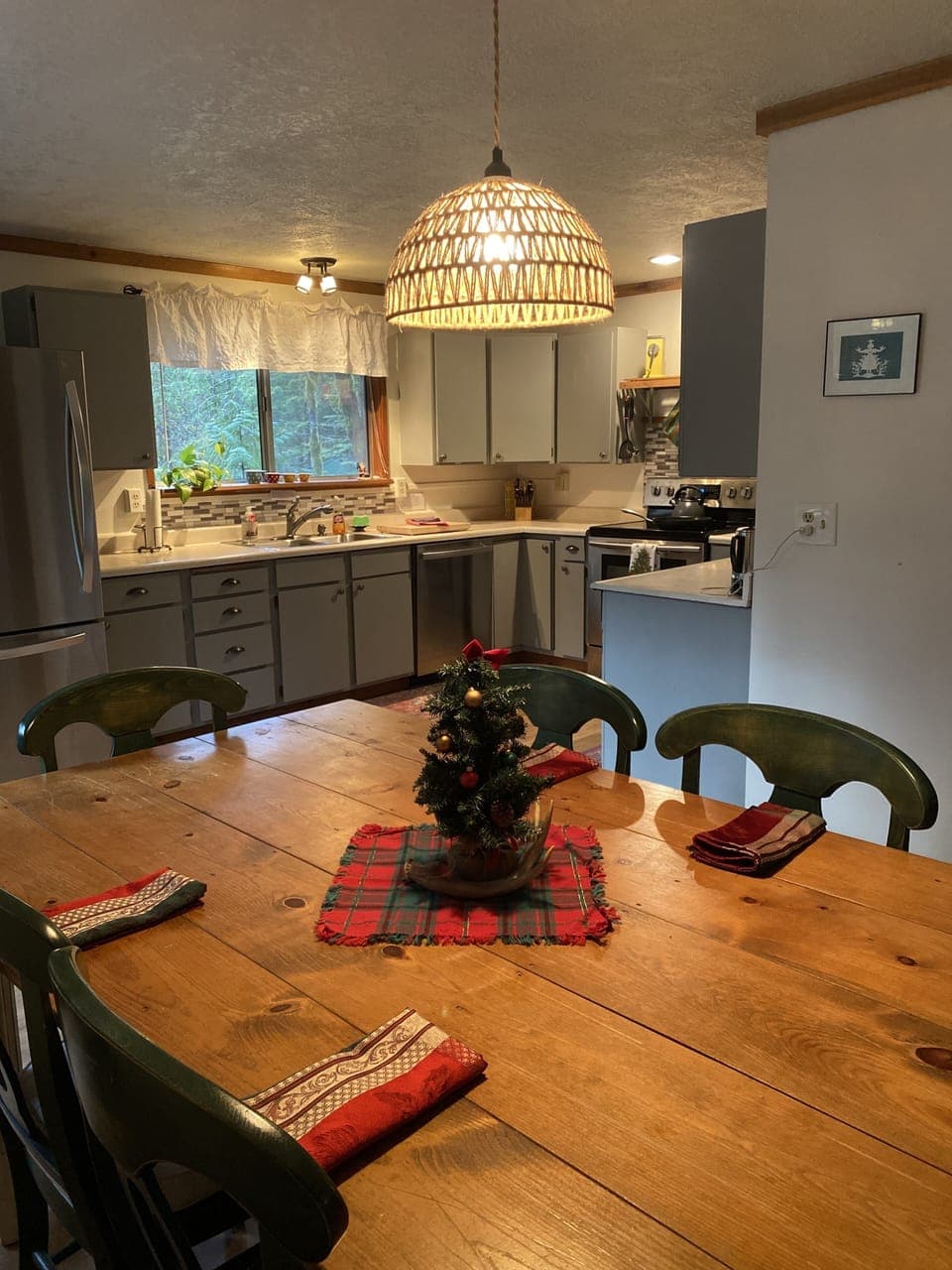 Dining table is open to kitchen and living room, an inviting open floor plan