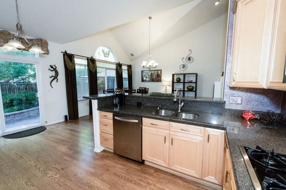Kitchen has door to fenced back yard.