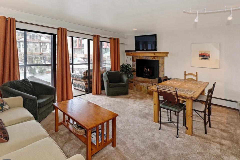 A cozy fireplace and flat screen w/DVD and movies  in your home away from home.