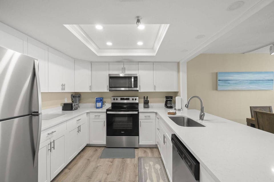 Updated Kitchen with Sleek White Cabinets and Stainless-Steel Appliances