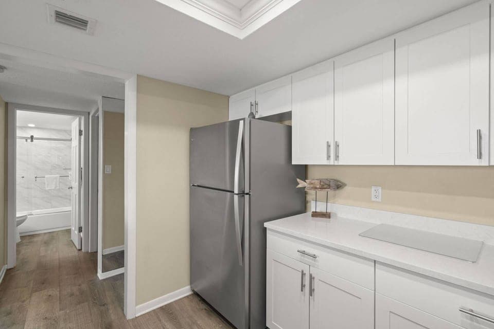 Updated Kitchen with Sleek White Cabinets and Stainless-Steel Appliances