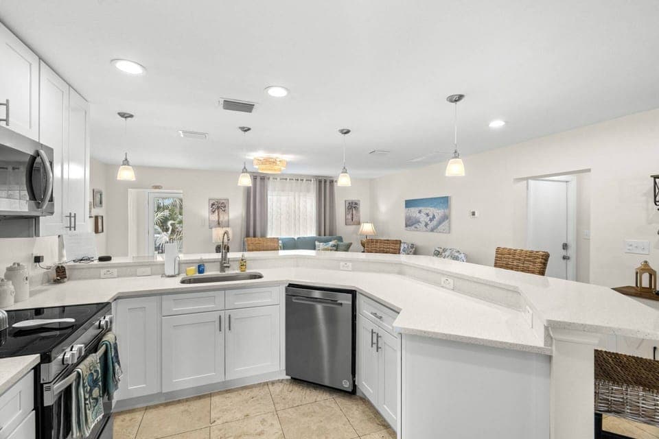 Beautifully Updated Kitchen with Sleek White Cabinets and Stainless-Steel Appliances