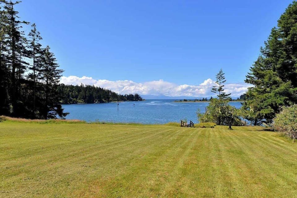 Large lawn which cascades down to the water.