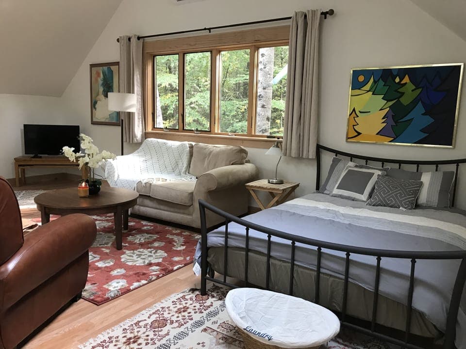Relaxing area with comfortable couch and chairs. TV with Netflix.