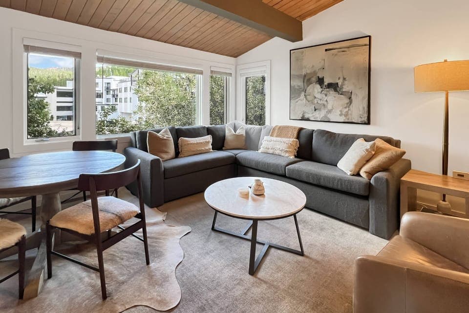 Look out to Snowmass Mountain in this cozy living room with designer touches