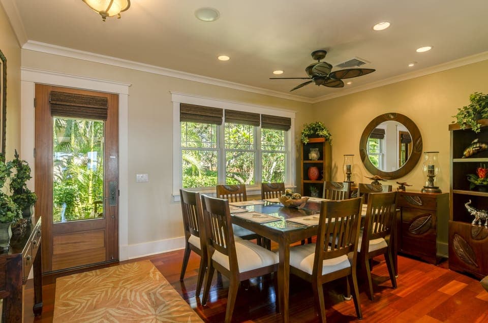 Dining Room - The back door opens to the dining area, with a table and seating for eight, with lush garden views.
