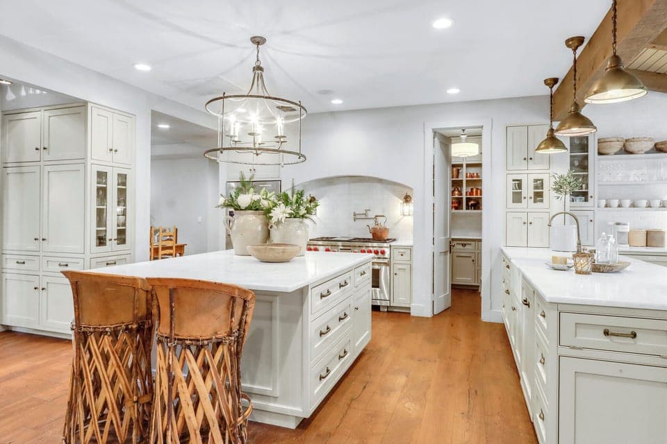 Step into this stunning chef's kitchen where elegant white cabinetry meets warm brass fixtures, creating your perfect culinary haven for memorable meals - Main House