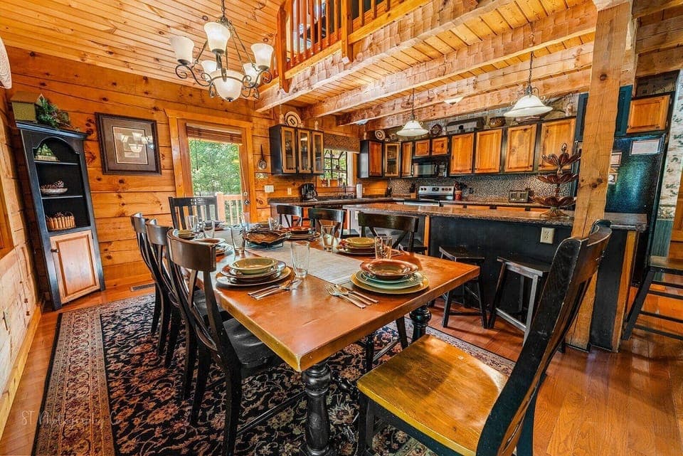 Enjoy meals together at the massive farmhouse table with views of the forest.